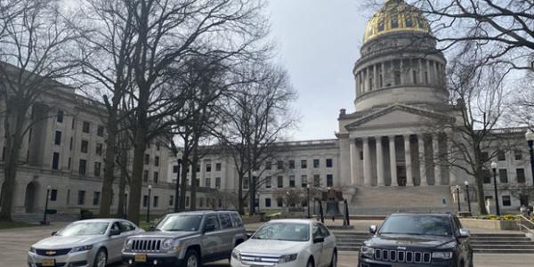 photo of fleet vehicles with capitol in background